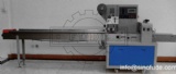 Biscuit flow wrapping machine